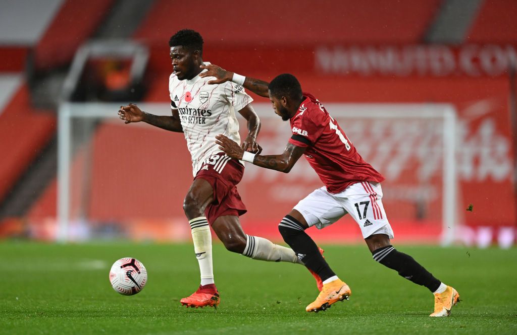 MANCHESTER, ENGLAND - NOVEMBER 01: Thomas Partey of Arsenal is put under pressure by Paul Pogba of Manchester United during the Premier League match between Manchester United and Arsenal at Old Trafford on November 01, 2020 in Manchester, England. Sporting stadiums around the UK remain under strict restrictions due to the Coronavirus Pandemic as Government social distancing laws prohibit fans inside venues resulting in games being played behind closed doors. (Photo by Shaun Botterill/Getty Images)