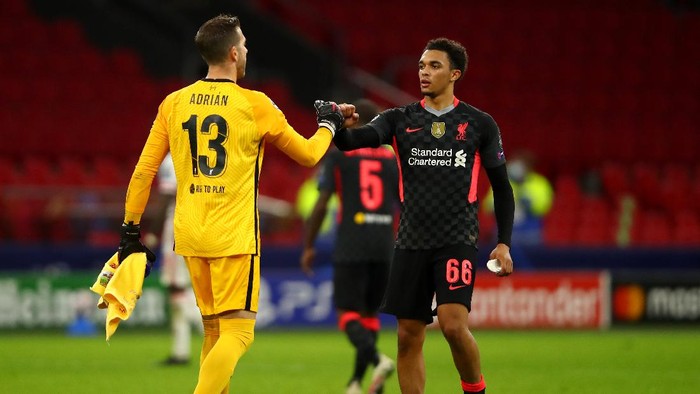 AMSTERDAM, NETHERLANDS - OCTOBER 21: Goalkeeper, Adrian and Trent Alexander-Arnold of Liverpool celebrate after victory in the UEFA Champions League Group D stage match between Ajax Amsterdam and Liverpool FC at Johan Cruijff Arena on October 21, 2020 in Amsterdam, Netherlands. (Photo by Dean Mouhtaropoulos/Getty Images)