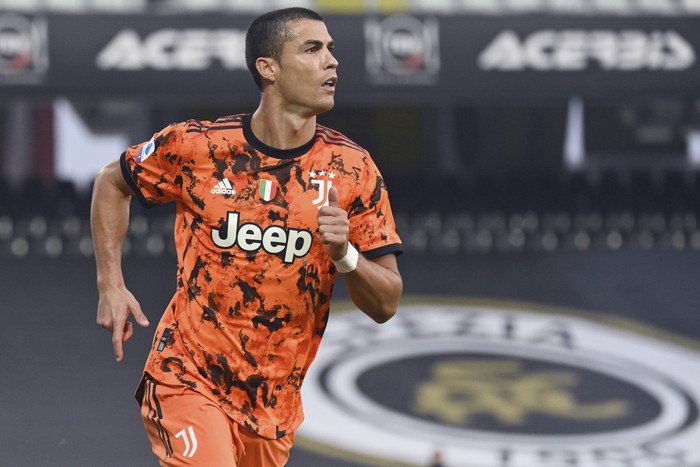 Juventus' Cristiano Ronaldo celebrates after scoring on a penalty his side's fourth goal, during the Serie A soccer match between Spezia and Juventus, at the Dino Manuzzi Stadium in Cesena, Italy, Sunday, Nov. 1, 2020. (Massimo Paolone/LaPresse via AP)