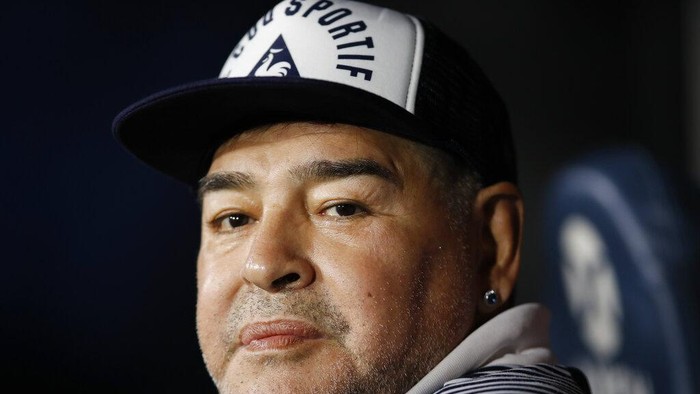FILE - In this March 7, 2020 file photo, Diego Maradona, coach of Gimnasia y Esgrima, sits on the bench prior to Argentinas soccer league match against Boca Juniors at La Bombonera stadium in Buenos Aires, Argentina. Maradona turns 60 on Friday, Oct. 30, 2020. (AP Photo/Natacha Pisarenko, File)