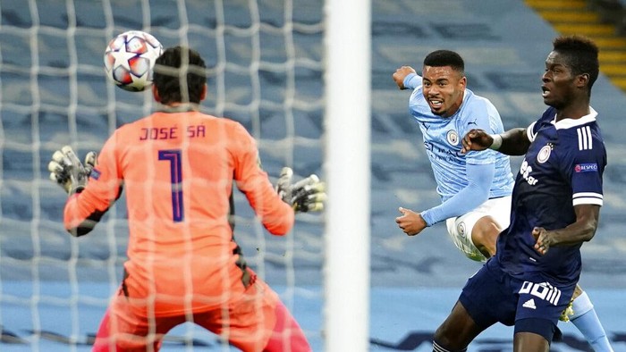 Manchester Citys Gabriel Jesus, centre, scores his sides second goal during the Champions League group C soccer match between Manchester City and Olympiacos at the Etihad stadium in Manchester, England, Tuesday, Nov. 3, 2020. (AP Photo/Dave Thompson)