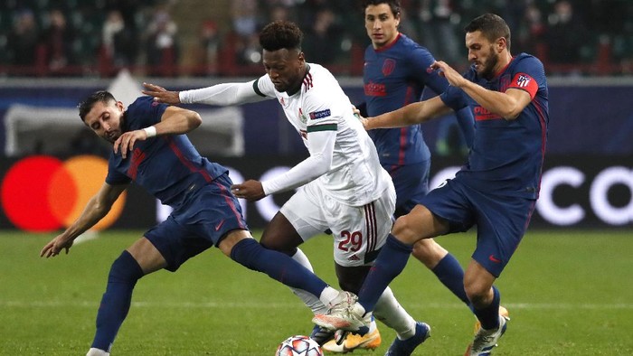 Atletico Madrids Hector Herrera, left, Atletico Madrids Koke, right, and Lokomotiv Moscows Ze Luis challenge for the ball during the Champions League Group A soccer match between Lokomotiv Moscow and Atletico Madrid in Moscow, Russia, Tuesday, Nov. 3, 2020. (Yuri Kochetkov/Pool via AP)