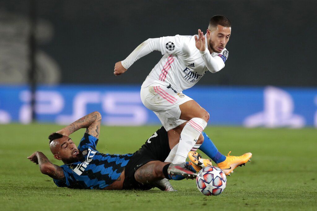 Real Madrid's Eden Hazard, right, controls the ball as Inter Milan's Arturo Vidal tries to stop him during the Champions League group B soccer match between Real Madrid and Inter Milan at the Alfredo Di Stefano stadium in Madrid, Spain, Tuesday, Nov. 3, 2020. (AP Photo/Bernat Armangue)