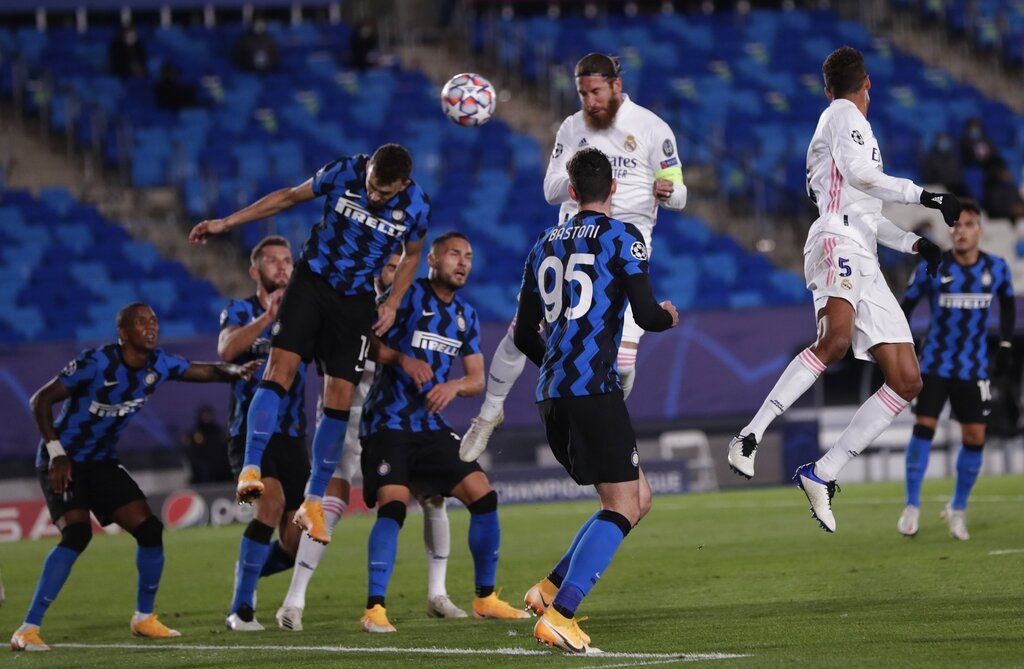 Real Madrid's Sergio Ramos, center, scores his side's second goal during the Champions League group B soccer match between Real Madrid and Inter Milan at the Alfredo Di Stefano stadium in Madrid, Spain, Tuesday, Nov. 3, 2020. (AP Photo/Bernat Armangue)