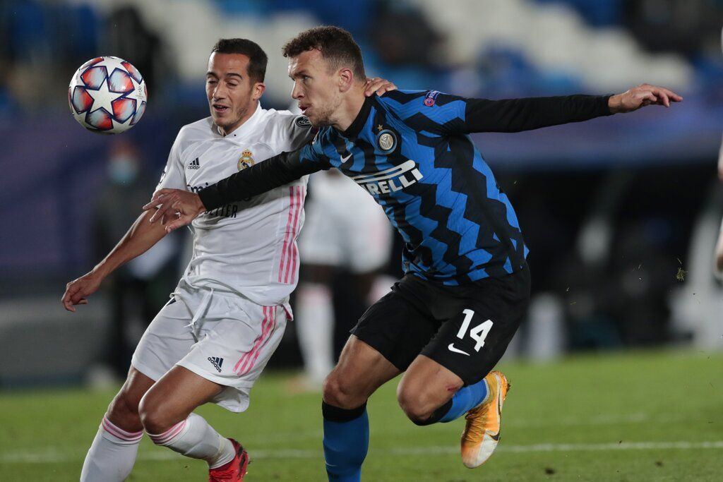 Inter Milan's Ivan Perisic, right, goes to score his side's second goal as Real Madrid's Marco Asensio tries to stop during the Champions League group B soccer match between Real Madrid and Inter Milan at the Alfredo Di Stefano stadium in Madrid, Spain, Tuesday, Nov. 3, 2020. (AP Photo/Bernat Armangue)