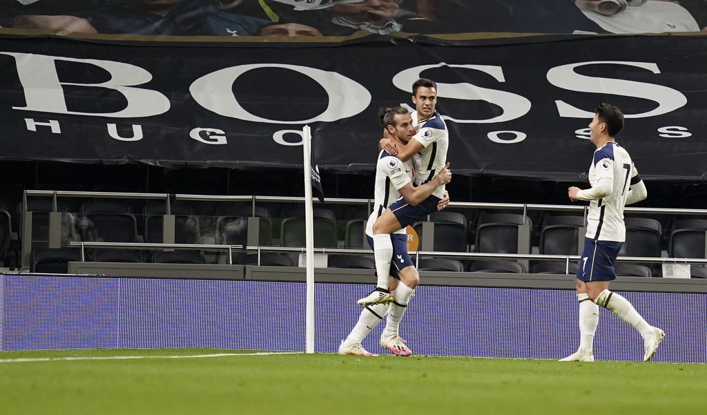 Tottenham's Gareth Bale, left, is congratulated by teammates Sergio Reguilon and Son Heung-min, right, after scoring his team's second goal during the English Premier League soccer match between Tottenham Hotspur and Brighton & Hove Albion at Tottenham Hotspur Stadium, London, Sunday, Nov. 1, 2020. (John Walton/Pool via AP)