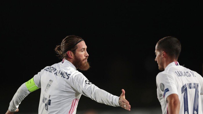 Real Madrids Sergio Ramos, left, celebrates with his teammate Real Madrids Lucas Vazquez after scoring his sides second goal during the Champions League group B soccer match between Real Madrid and Inter Milan at the Alfredo Di Stefano stadium in Madrid, Spain, Tuesday, Nov. 3, 2020. (AP Photo/Bernat Armangue)