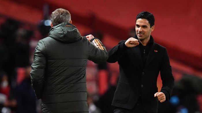 Liga Inggris MANCHESTER, ENGLAND - NOVEMBER 01: Ole Gunnar Solskjaer, Manager of Manchester United interacts with Mikel Arteta, Manager of Arsenal following the Premier League match between Manchester United and Arsenal at Old Trafford on November 01, 2020 in Manchester, England. Sporting stadiums around the UK remain under strict restrictions due to the Coronavirus Pandemic as Government social distancing laws prohibit fans inside venues resulting in games being played behind closed doors. (Photo by Paul Ellis - Pool/Getty Images)