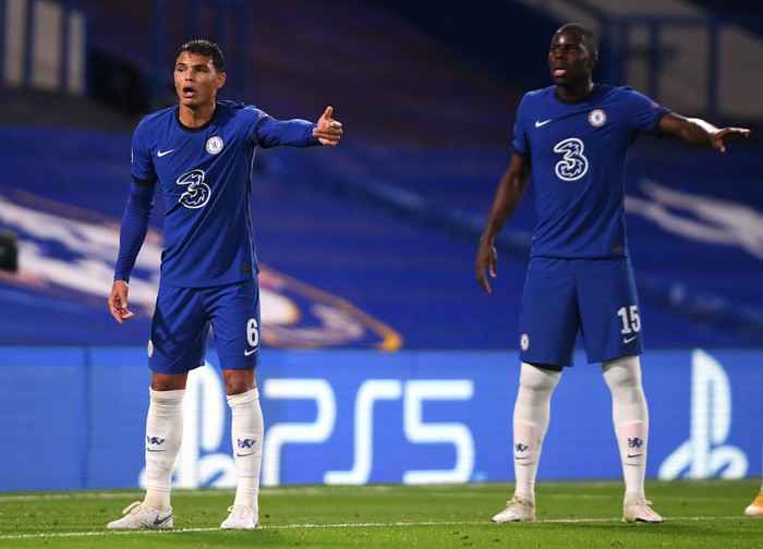 LONDON, ENGLAND - OCTOBER 20: Thiago Silva and Kurt Zouma of Chelsea gesture during the UEFA Champions League Group E stage match between Chelsea FC and FC Sevilla at Stamford Bridge on October 20, 2020 in London, England. Sporting stadiums around the UK remain under strict restrictions due to the Coronavirus Pandemic as Government social distancing laws prohibit fans inside venues resulting in games being played behind closed doors. (Photo by Mike Hewitt/Getty Images)