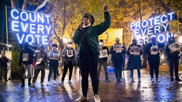 Travonna Thompson-Wiley, with Black Action Coalition, speaks at the Count Every Vote - Protect Every Person rally and march in Occidental Park in Seattle on Wednesday, Nov. 4, 2020. A coalition of groups organized the event, which drew hundreds of people. The coalition demanded that every vote is counted and orderly transition of power, as well as the elimination the electoral college, defunding the police, eradicating ICE/CBP and investing in Black communities. (Erika Schultz/The Seattle Times via AP)