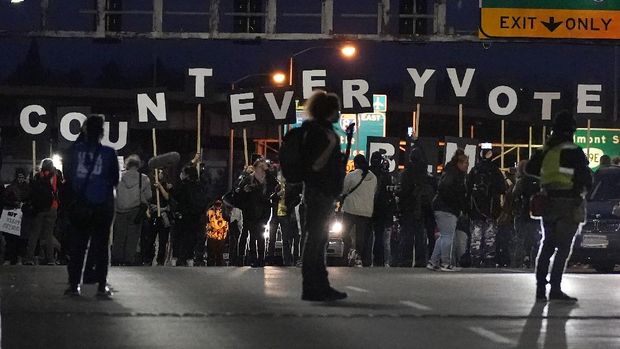 Protesters hold letters that spell Count Every Vote as they cross an overpass while marching in Portland, Ore., Wednesday, Nov. 4, 2020, following Tuesday's election. (AP Photo/Marcio Jose Sanchez)