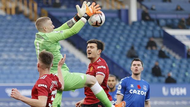 Everton's goalkeeper Jordan Pickford makes a save during the English Premier League soccer match between Everton and Manchester United at the Goodison Park stadium in Liverpool, England, Saturday, Nov. 7, 2020. (Clive Brunskill/Pool via AP)