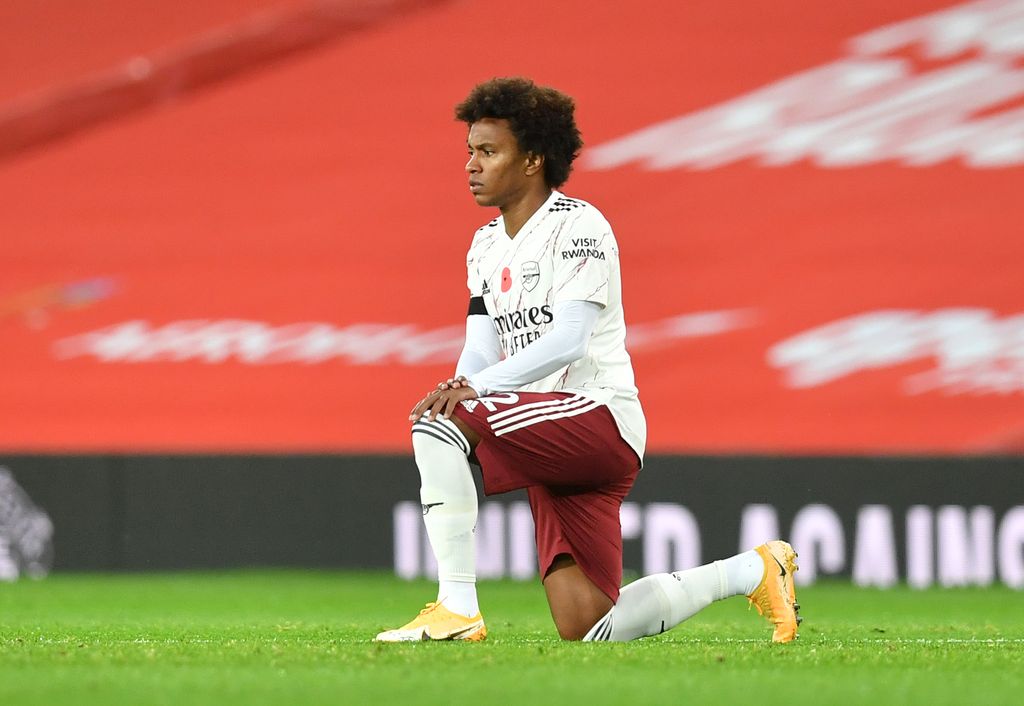 Willian MANCHESTER, ENGLAND - NOVEMBER 01: Willian of Arsenal takes a knee in support of the Black Lives Matter movement prior to the Premier League match between Manchester United and Arsenal at Old Trafford on November 01, 2020 in Manchester, England. Sporting stadiums around the UK remain under strict restrictions due to the Coronavirus Pandemic as Government social distancing laws prohibit fans inside venues resulting in games being played behind closed doors. (Photo by Paul Ellis - Pool/Getty Images)