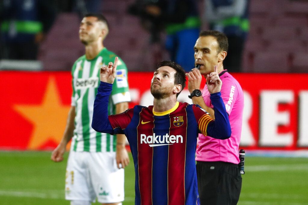 Barcelona's Lionel Messi celebrates after scoring his side's fourth goal during the Spanish La Liga soccer match between FC Barcelona and Betis at the Camp Nou stadium in Barcelona, Spain, Saturday, Nov. 7, 2020. (AP Photo/Joan Monfort)