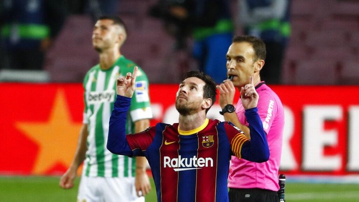 Barcelonas Lionel Messi celebrates after scoring his sides fourth goal during the Spanish La Liga soccer match between FC Barcelona and Betis at the Camp Nou stadium in Barcelona, Spain, Saturday, Nov. 7, 2020. (AP Photo/Joan Monfort)