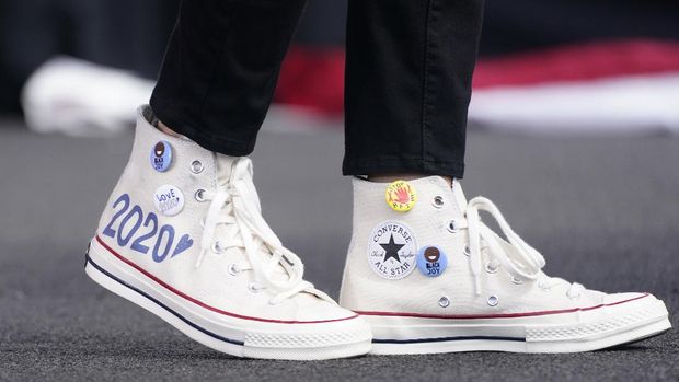 Converse high-top sneakers of Democratic vice presidential candidate Sen. Kamala Harris, D-Calif., are shown as she speaks at a drive-in early voting event, Saturday, Oct. 31, 2020, in Miami, Fla. (AP Photo/Wilfredo Lee)