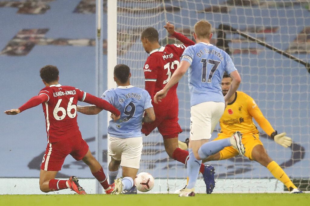 Manchester City's Gabriel Jesus, second left, scores his team's first goal during the English Premier League soccer match between Manchester City and Liverpool at the Etihad Stadium in Manchester, England, on Sunday, November 8, 2020 ( Martin Rickett / Pool via AP)