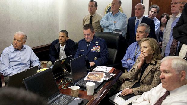 In this image released by the White House and digitally altered by the source to diffuse the paper in front of Secretary of State Hillary Rodham Clinton, President Barack Obama and Vice President Joe Biden, along with with members of the national security team, receive an update on the mission against Osama bin Laden in the Situation Room of the White House, Sunday, May 1, 2011, in Washington. (Pete Souza/The White House via AP)