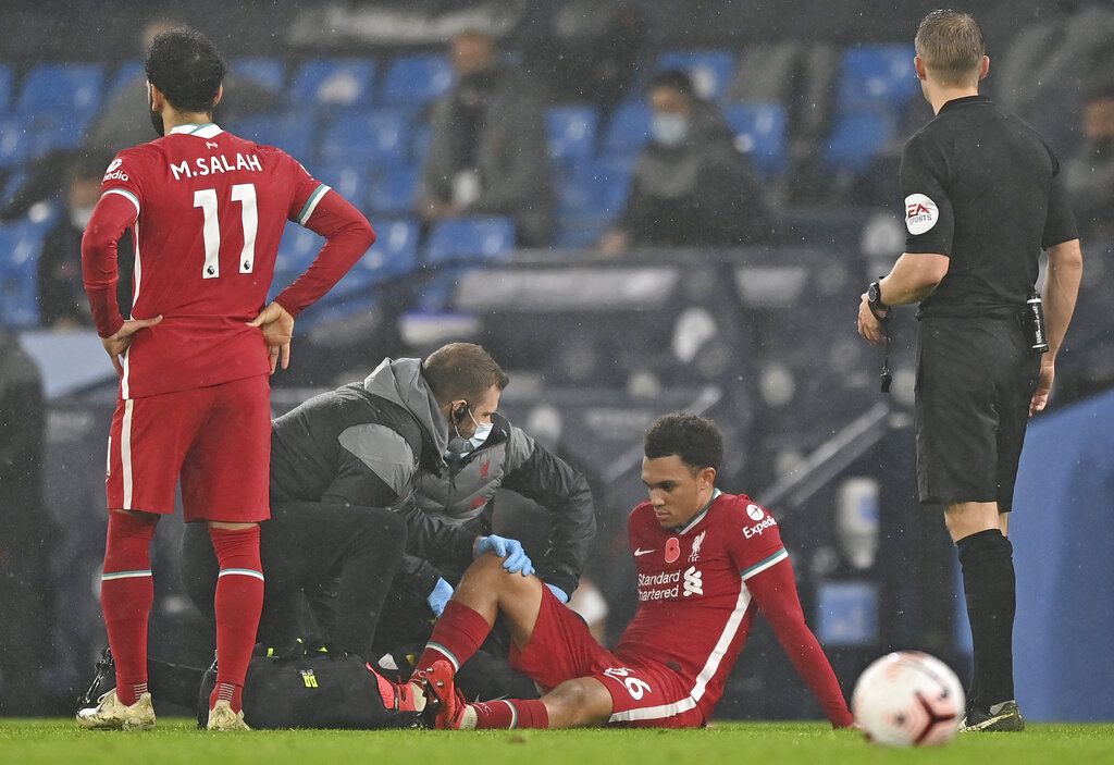 Liverpool's Trent Alexander-Arnold gets treatment after getting injured during the English Premier League soccer match between Manchester City and Liverpool at the Etihad stadium in Manchester, England, Sunday, Nov. 8, 2020. (Shaun Botterill/Pool via AP)