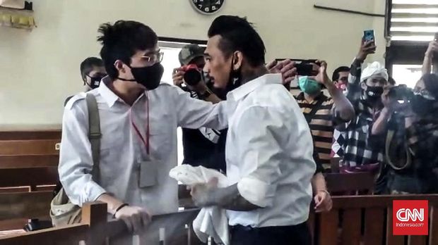 Dokter Tirta sempat berbincang dengan terdakwa kasus ujaran kebencian I Gede Ari Astina alias Jerinx sebelum menjalani sidang di Pengadilan Negeri Denpasar, Bali, Selasa (10/11)KREDITPutu