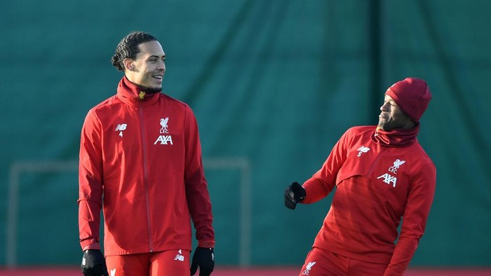LIVERPOOL, ENGLAND - DECEMBER 09: Virgil van Dijk of Liverpool and Georginio Wijnaldum of Liverpool share a joke during a training session ahead of their UEFA Champions League Group E match against RB Salzburg at Melwood Training Ground on December 09, 2019 in Liverpool, England. (Photo by Nathan Stirk/Getty Images)