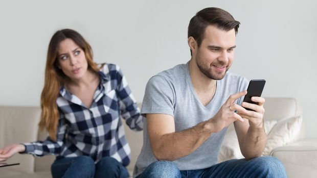 Disloyal boyfriend caught by his angry girlfriend dating with another girl in a restaurant