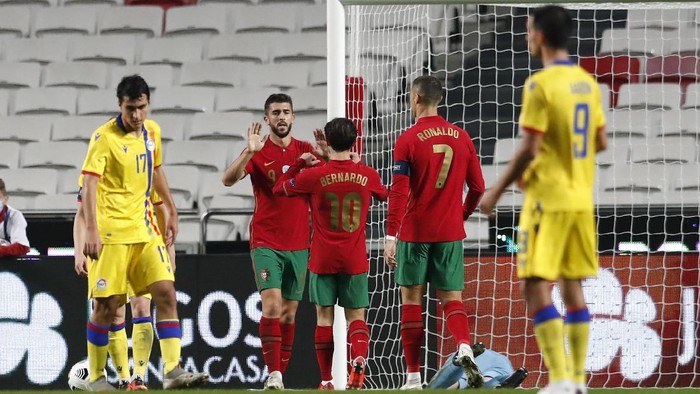 Portugals Paulinho, second left, is congratulated by teammates after scoring his teams fourth goal during the international friendly soccer match between Portugal and Andorra at the Luz stadium in Lisbon, Portugal, Wednesday, Nov. 11, 2020. (AP Photo/Armando Franca)