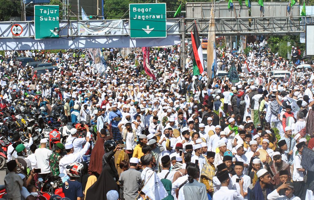 Ribuan jamaah menyambut kedatangan Imam Besar Habib Rizieq Shihab di jalur Puncak, Simpang Gadog, Ciawi, Kabupaten Bogor, Jawa Barat, Jumat (13/11/2020). Kedatangan Imam Besar Habib Rizieq Shihab ke Pondok Pesantren (Ponpes) Alam Agrokultural Markaz Syariah DPP FPI, Megamendung, Kabupaten Bogor untuk melaksanakan salat Jumat berjamaah sekaligus peletakan batu pertama pembangunan masjid di Ponpes tersebut. ANTARA FOTO/Arif Firmansyah/foc.