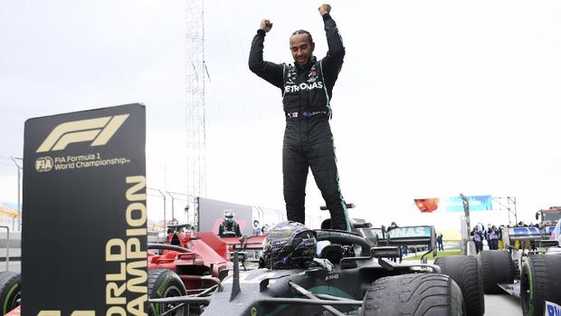 Mercedes driver Lewis Hamilton of Britain celebrates after winning the Turkish Formula One Grand Prix at the Istanbul Park circuit racetrack in Istanbul, Sunday, Nov. 15, 2020. (Clive Mason/Pool via AP)