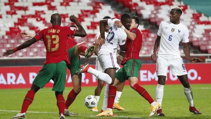 Portugal France Nations League Soccer Frances Marcus Thuram, center, tries to back heel the ball during the UEFA Nations League soccer match between Portugal and France at the Luz stadium in Lisbon, Saturday, Nov. 14, 2020. (AP Photo/Armando Franca)