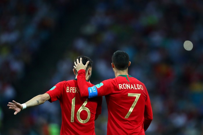 Bruno Fernandes Ronaldo SOCHI, RUSSIA - JUNE 15: Cristiano Ronaldo of Portugal embraces team mate Bruno Fernandes during the 2018 FIFA World Cup Russia group B match between Portugal and Spain at Fisht Stadium on June 15, 2018 in Sochi, Russia. (Photo by Dean Mouhtaropoulos/Getty Images)