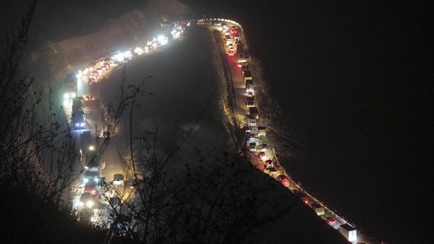 Cars and trucks stuck in a huge traffic jam climbing along the road from Kalbajar to a mountain pass leaving the separatist region of Nagorno-Karabakh to Armenia, on Saturday, Nov. 14, 2020. The territory is to be turned over to Azerbaijan on Sunday as part of territorial concessions in an agreement to end six weeks of intense fighting with Armenian forces. Hundreds of thousands of Azeris were displaced by the war that ended in 1994. It is unclear when any civilians might try to settle in Karvachar — which will now be known by its Azeri name Kalbajar — or elsewhere. (AP Photo/Dmitry Lovetsky)