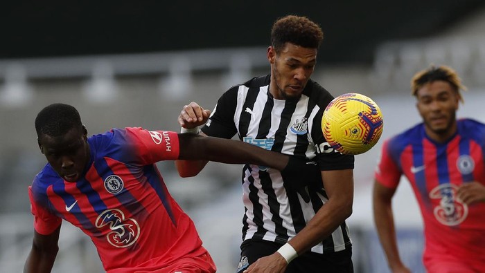 Newcastles Joelinton, center, is challenged by Chelseas Kurt Zouma during the English Premier League soccer match between Newcastle United v Chelsea at the St. James Park in Newcastle, England, Saturday, Nov. 21, 2020. (Lee Smith/ Pool via AP)