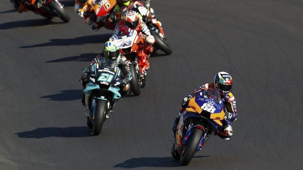 MotoGP rider Miguel Oliveira of Portugal steers his motorcycle ahead of Franco Morbidelli of Italy and Jack Miller of Australia during the MotoGP race of the Portuguese Motorcycle Grand Prix, the last race of the season, at the Algarve International circuit near Portimao, Portugal, Sunday, Nov. 22, 2020. (AP Photo/Armando Franca)