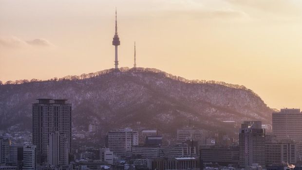 sunset over snow covered namsan and the city. Taken from naksan park