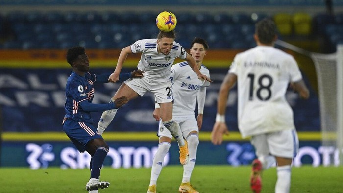 Leeds Uniteds Luke Ayling heads the ball during an English Premier League soccer match between Leeds United and Arsenal at Elland Road Stadium in Leeds, England, Sunday Nov. 22, 2020. (Paul Ellis/Pool Via AP)