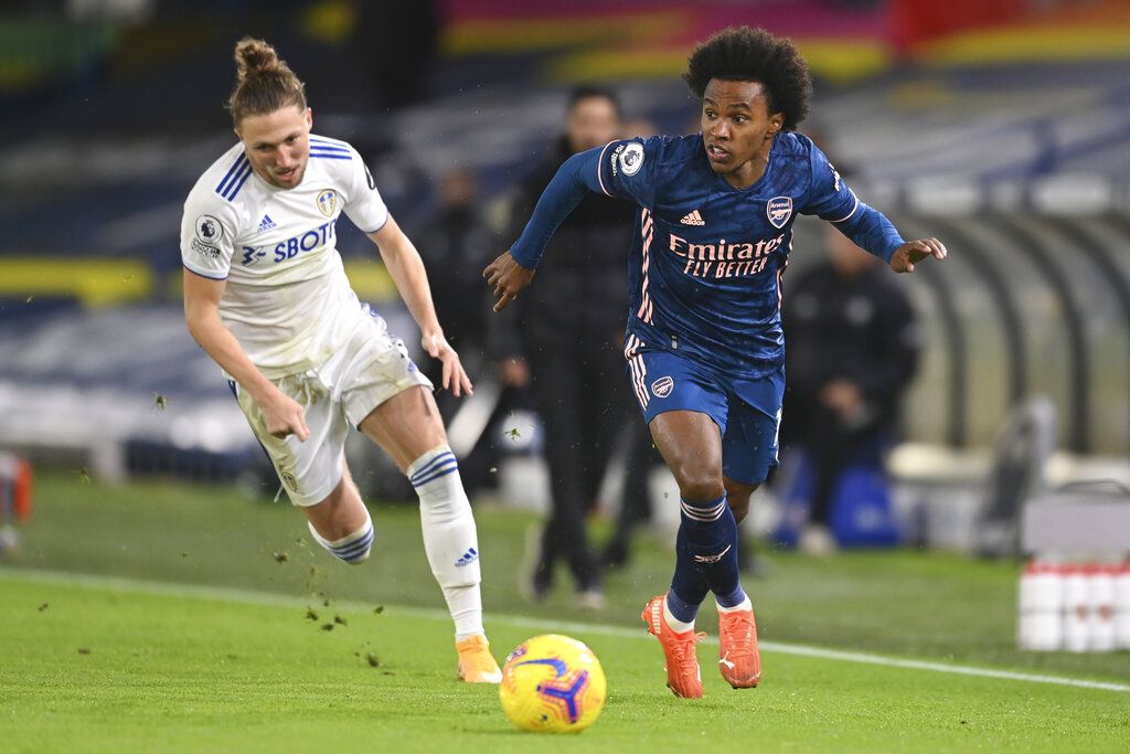 Arsenal's Willian, right, gets past Leeds United's Luke Ayling during an English Premier League soccer match between Leeds United and Arsenal at Elland Road Stadium in Leeds, England, Sunday Nov. 22, 2020. (Michael Regan/Pool Via AP)