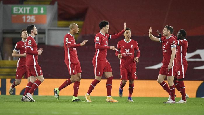 Liverpool vs Leicester City Liverpools team players celebrate after Leicesters Jonny Evans scored an own goal during the English Premier League soccer match between Liverpool and Leicester City at Anfield stadium in Liverpool, England, Sunday, Nov. 22, 2020. (Peter Powell/Pool via AP)