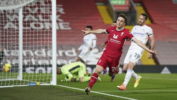 Liverpool's Diogo Jota, center, celebrates after scoring his sides second goal during the English Premier League soccer match between Liverpool and Leicester City at Anfield stadium in Liverpool, England, Sunday, Nov. 22, 2020. (AP Photo/Jon Super)