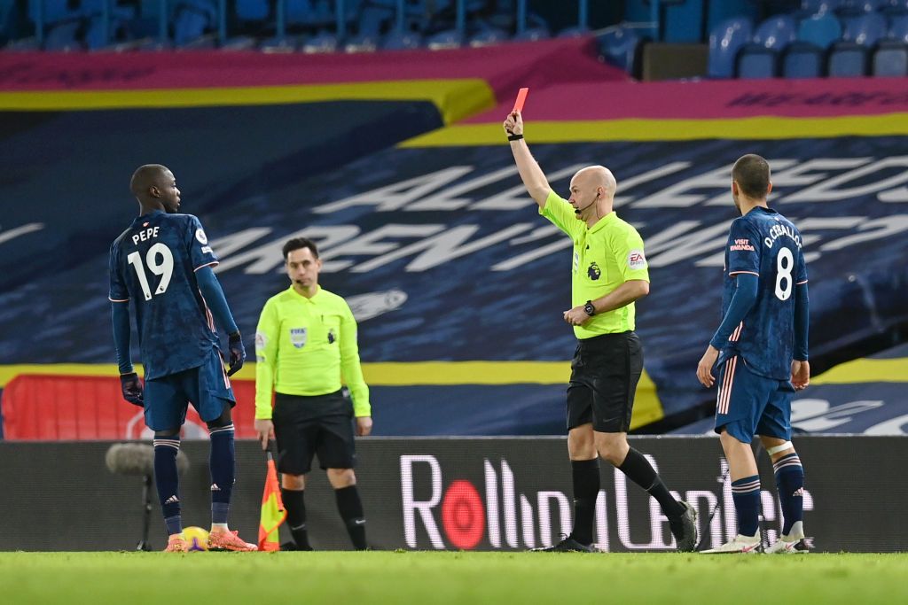 LEEDS, ENGLAND - NOVEMBER 22: Nicolas Pepe of Arsenal(R) is shown a red card by Match Referee Anthony Taylor(L) during the Premier League match between Leeds United and Arsenal at Elland Road on November 22, 2020 in Leeds, England. Sporting stadiums around the UK remain under strict restrictions due to the Coronavirus Pandemic as Government social distancing laws prohibit fans inside venues resulting in games being played behind closed doors. (Photo by Molly Darlington - Pool/Getty Images)