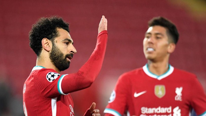LIVERPOOL, ENGLAND - OCTOBER 27: Mohamed Salah of Liverpool  celebrates after he scores his teams second goal from the penalty spot during the UEFA Champions League Group D stage match between Liverpool FC and FC Midtjylland at Anfield on October 27, 2020 in Liverpool, England. Sporting stadiums around the UK remain under strict restrictions due to the Coronavirus Pandemic as Government social distancing laws prohibit fans inside venues resulting in games being played behind closed doors. (Photo by Peter Powell -