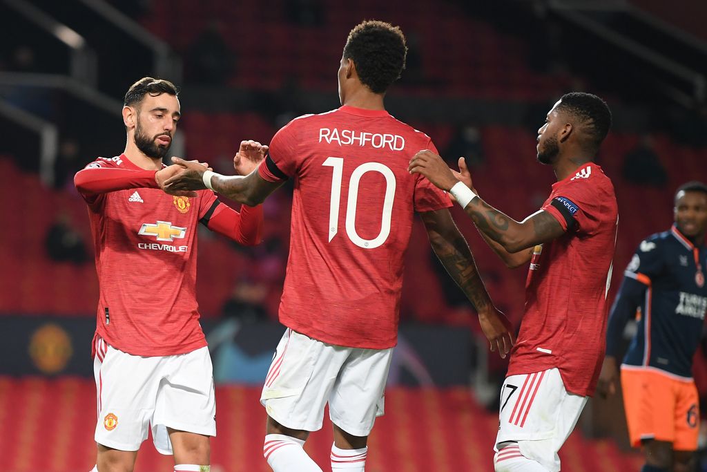 MANCHESTER, ENGLAND - NOVEMBER 24: Marcus Rashford of Manchester United celebrates after scoring their sides third goal with Bruno Fernandes (L) and Fred (R) during the UEFA Champions League Group H stage match between Manchester United and İstanbul Basaksehir at Old Trafford on November 24, 2020 in Manchester, England. Sporting stadiums around the UK remain under strict restrictions due to the Coronavirus Pandemic as Government social distancing laws prohibit fans inside venues resulting in games being played behind closed doors. (Photo by Michael Regan/Getty Images)