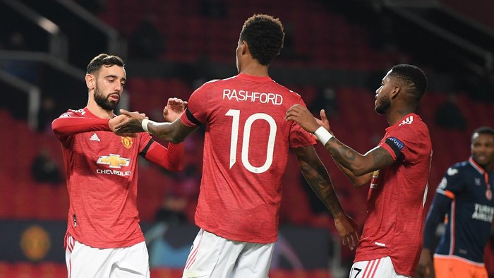 MANCHESTER, ENGLAND - NOVEMBER 24: Marcus Rashford of Manchester United celebrates after scoring their sides third goal with Bruno Fernandes (L)  and Fred (R) during the UEFA Champions League Group H stage match between Manchester United and İstanbul Basaksehir at Old Trafford on November 24, 2020 in Manchester, England. Sporting stadiums around the UK remain under strict restrictions due to the Coronavirus Pandemic as Government social distancing laws prohibit fans inside venues resulting in games being played behind closed doors. (Photo by Michael Regan/Getty Images)