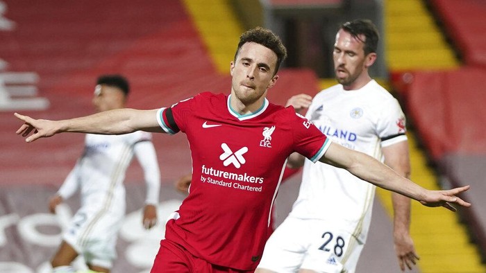 Liverpools Diogo Jota, center, celebrates after scoring his sides second goal during the English Premier League soccer match between Liverpool and Leicester City at Anfield stadium in Liverpool, England, Sunday, Nov. 22, 2020. (AP Photo/Jon Super)