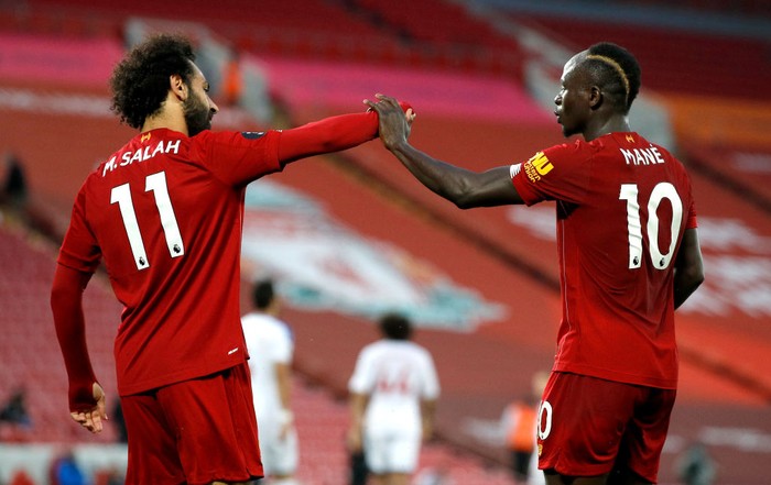 LIVERPOOL, ENGLAND - JUNE 24: Sadio Mane of Liverpool celebrates with Mohamed Salah of Liverpool after scoring his sides fourth goal during the Premier League match between Liverpool FC and Crystal Palace at Anfield on June 24, 2020 in Liverpool, England. (Phil Noble/Pool via Getty Images)