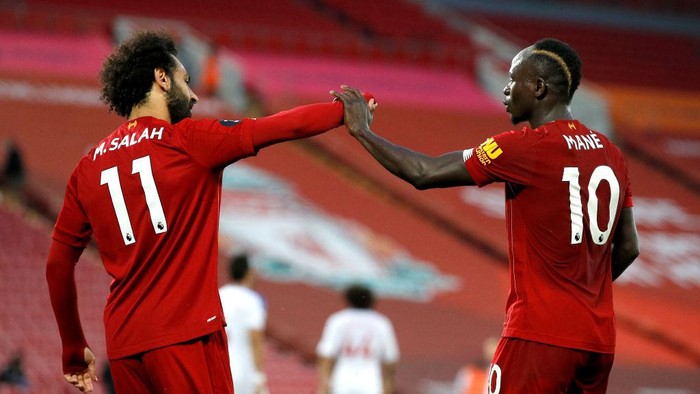 LIVERPOOL, ENGLAND - JUNE 24: Sadio Mane of Liverpool celebrates with Mohamed Salah of Liverpool after scoring his sides fourth goal during the Premier League match between Liverpool FC and Crystal Palace at Anfield on June 24, 2020 in Liverpool, England. (Phil Noble/Pool via Getty Images)