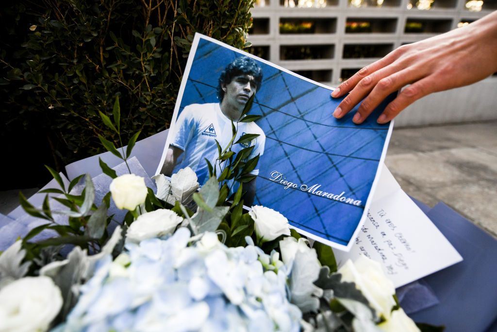 BEIJING, CHINA - NOVEMBER 26:  A staff arranged a photo in the Argentine Embassy for Mourning Diego Maradona on November 26, 2020 in Beijing, China.Diego Maradona, considered one of the biggest football stars in history, died at 60 from a heart attack on Wednesday in Buenos Aires.   (Photo by Di Yin/Getty Images)
