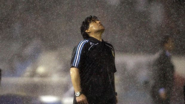 FILE - In this Oct. 10, 2009 file photo, under the pouring rain, Argentina's coach Diego Maradona looks up under the pouring rain during a 2010 World Cup qualifying soccer match against Peru, in Buenos Aires. Argentina won 2-1. The Argentine soccer great who was among the best players ever and who led his country to the 1986 World Cup title before later struggling with cocaine use and obesity, died from a heart attack on Wednesday, Nov. 25, 2020, at his home in Buenos Aires. He was 60. (AP Photo/Natacha Pisarenko, File)