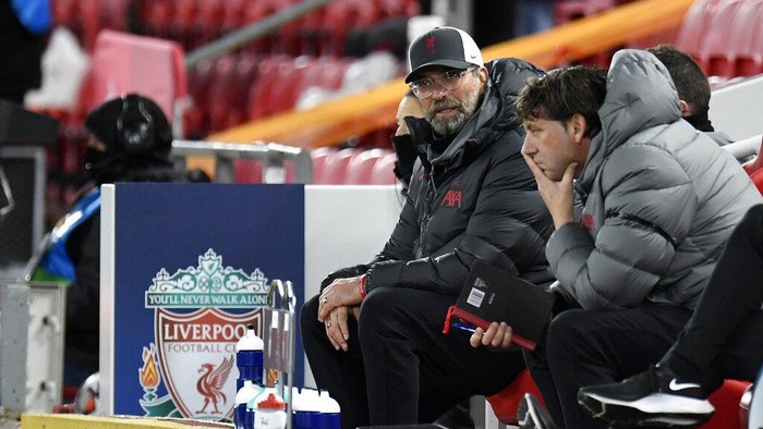 Liverpools manager Jurgen Klopp, left, looks out from the bench during the Champions League group D soccer match between Liverpool and Atalanta at Anfield stadium in Liverpool, England, Wednesday, Nov. 25, 2020. (Peter Powell/Pool via AP)