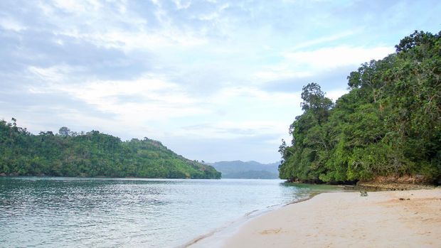 Sendang biru beach in the southern part of Malang, east java indonesia with long tail boat, sail boat, and yacht